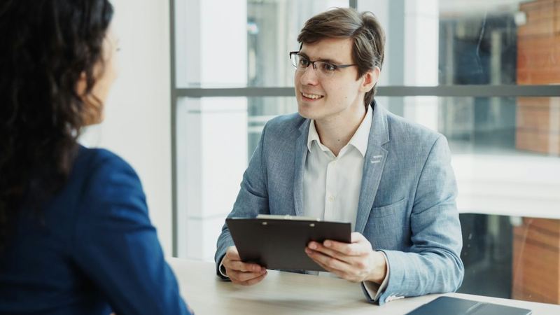 Recruiter holding a clipboard during an interview
